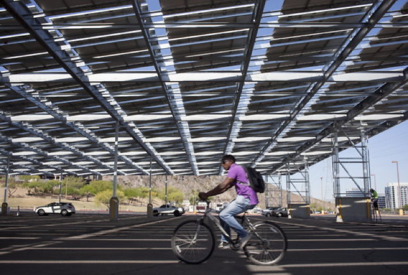 Lot59A-cyclist-pedals-through-a-solar-parking-lot-at-ASU